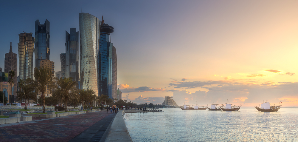 Shoreline of Doha marina with pastel skies at dusk. Visit on our Doha Holiday Packages 2023