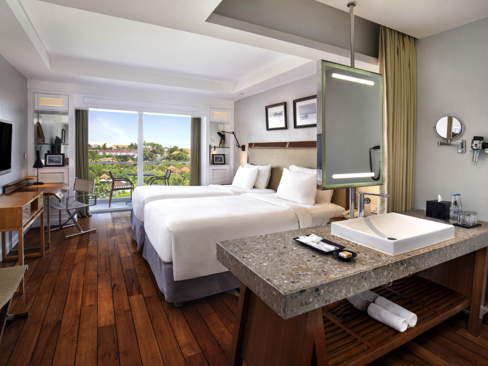 Bright Superior Twin Hotel Room with modern fittings and traditional wood floor